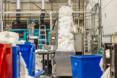 Bow Valley Linen's tunnel washer loaded with soiled linens
